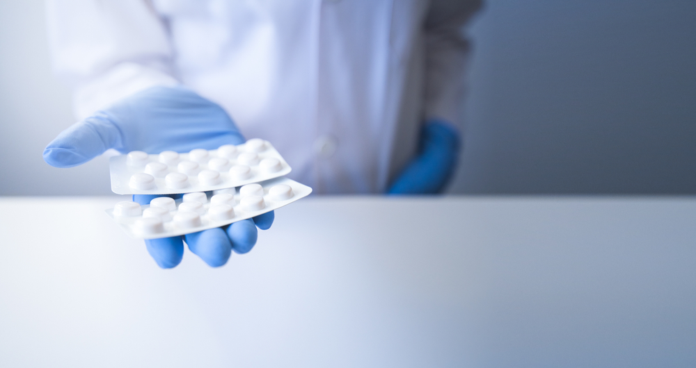 Pharmacist Hand Presenting Pills in Blister Packaging