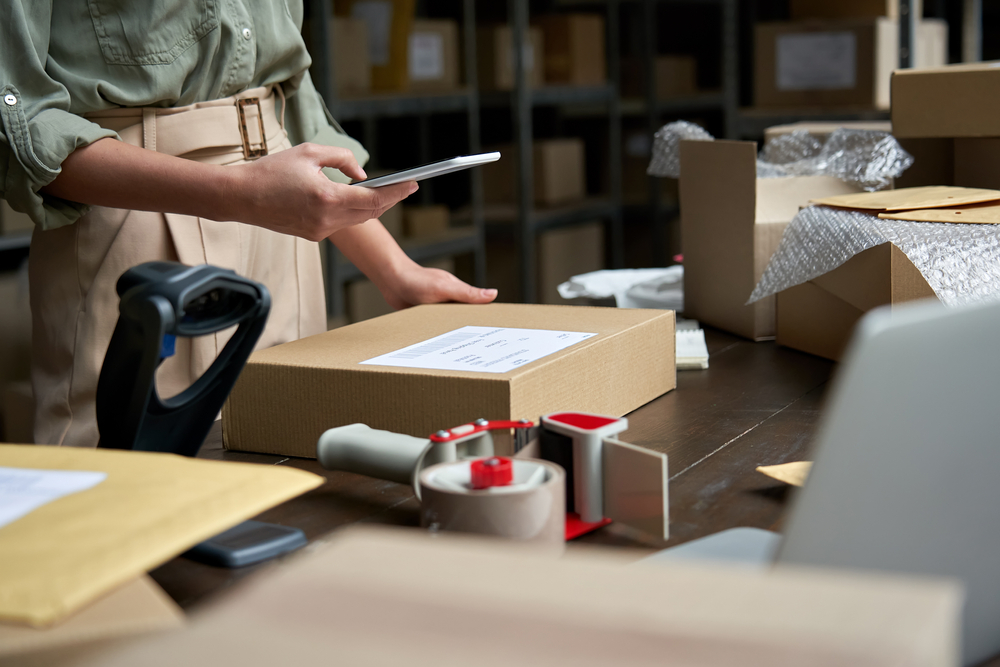 Small business owner reviews her packaging supplies
