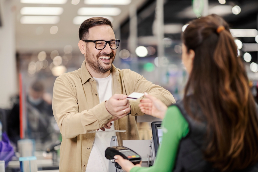 Customer gives a credit card to the cashier