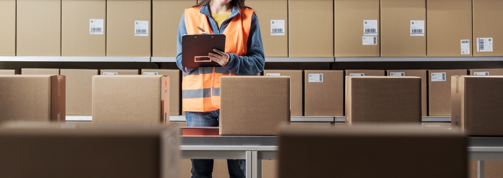 Worker checking boxes for kitting and fulfillment